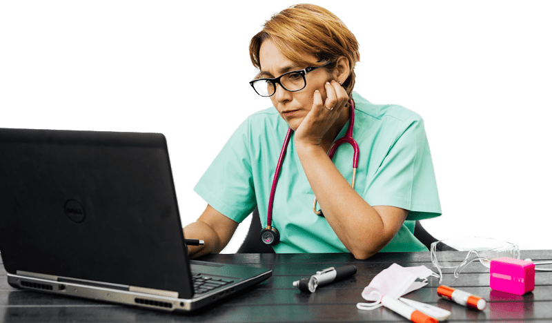Healthcare professional reading the Benchmark Systems 2022 Guide to Outsourcing Medical Billing Services on their laptop